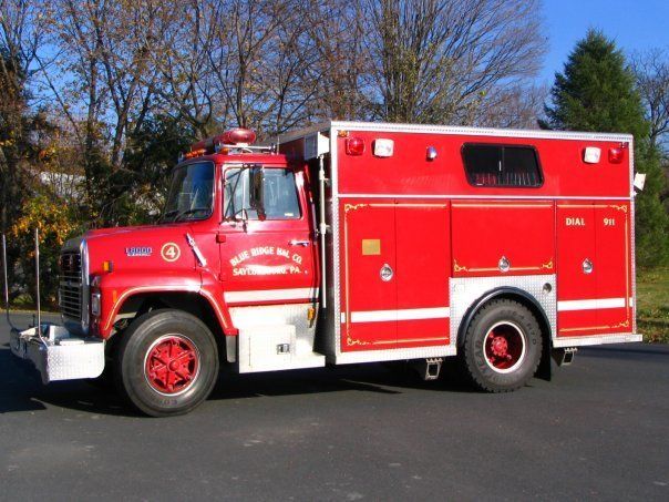 A red and white fire truck is parked on the side of the road