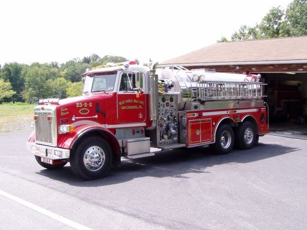 A red fire truck is parked in front of a garage