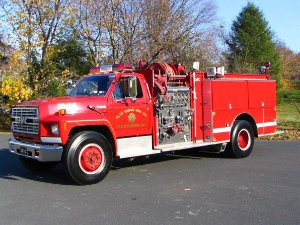 A red fire truck is parked on the side of the road