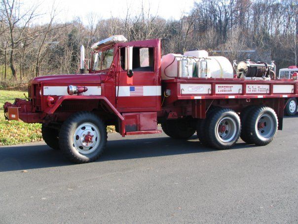 A red truck is parked on the side of the road