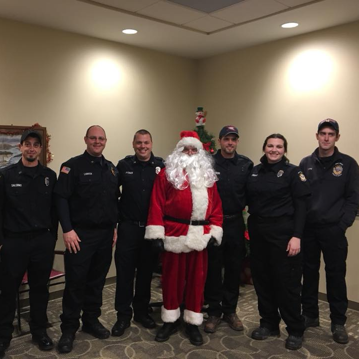 A group of police officers pose with santa claus