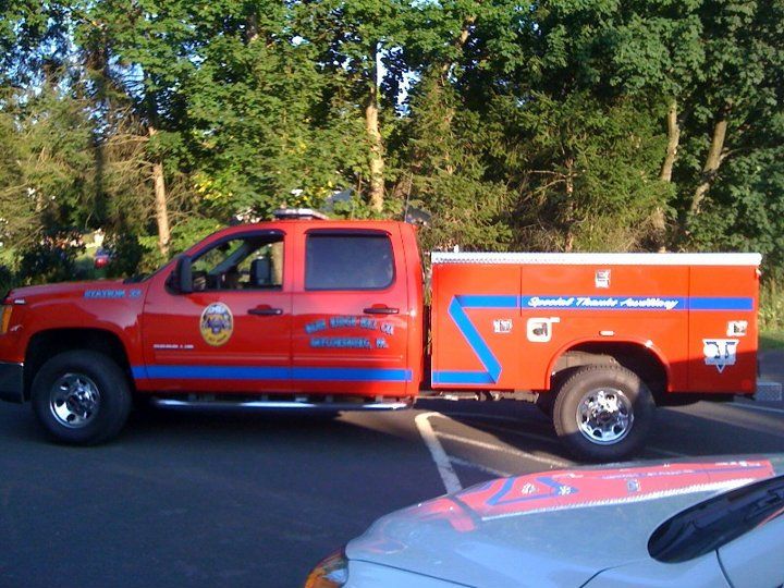 A red truck with the letter c on the side