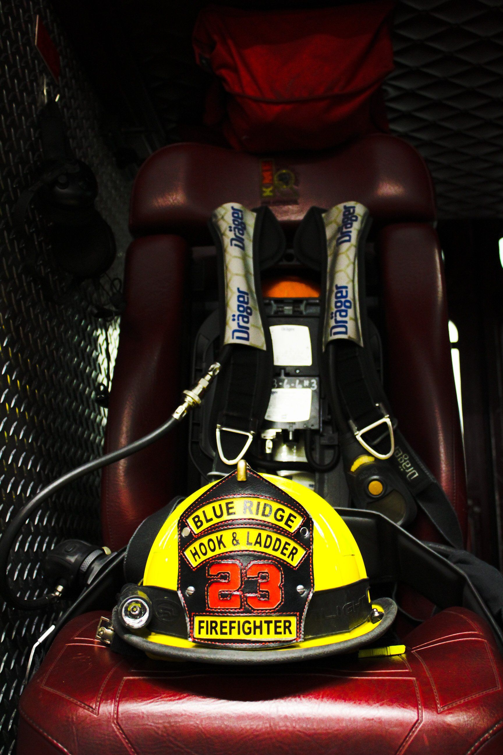 A firefighter 's helmet with the number 23 on it