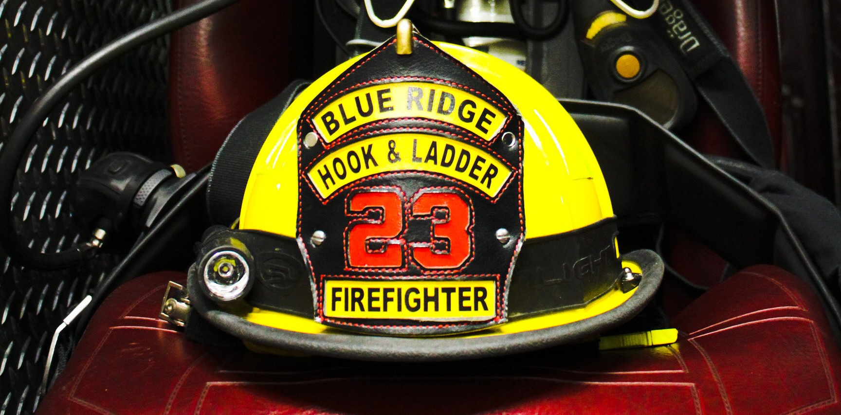 A firefighter 's helmet with the number 23 on it