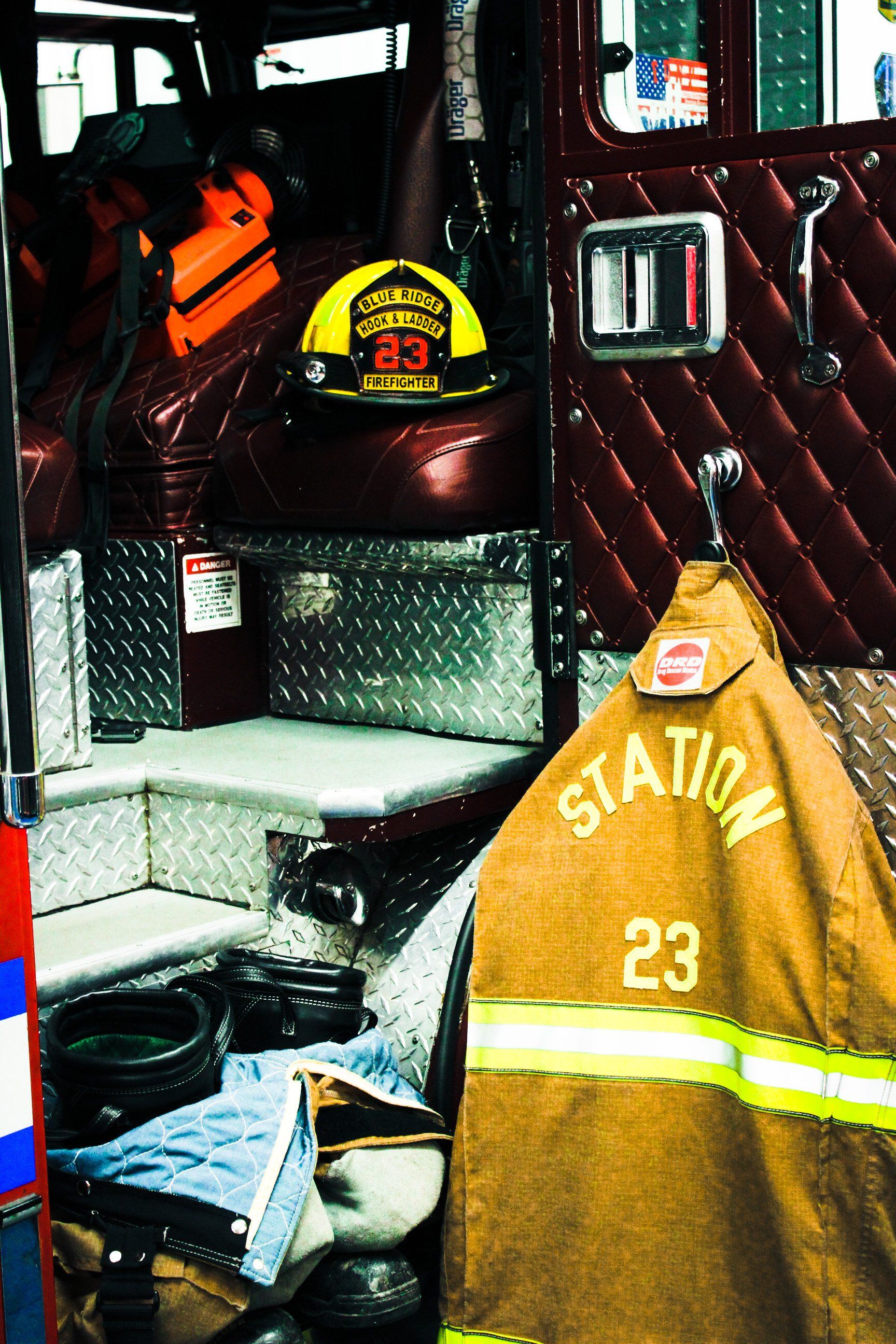 A fireman 's helmet is hanging on the side of a fire truck ..