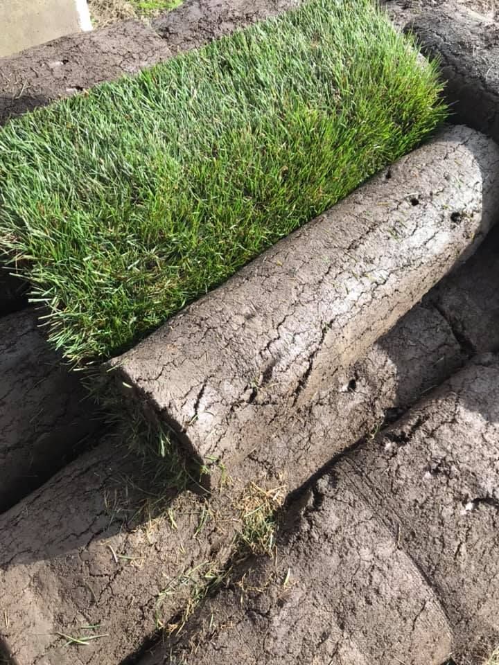 A pile of grass rolls sitting on top of each other.