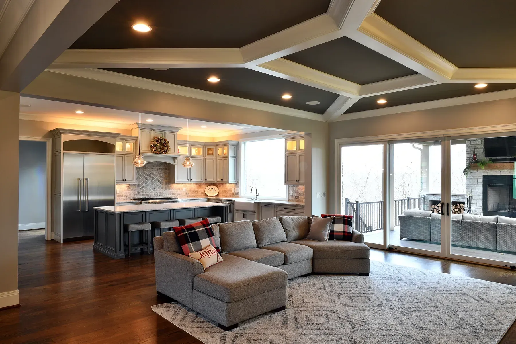 A living room with a sectional couch and a rug.