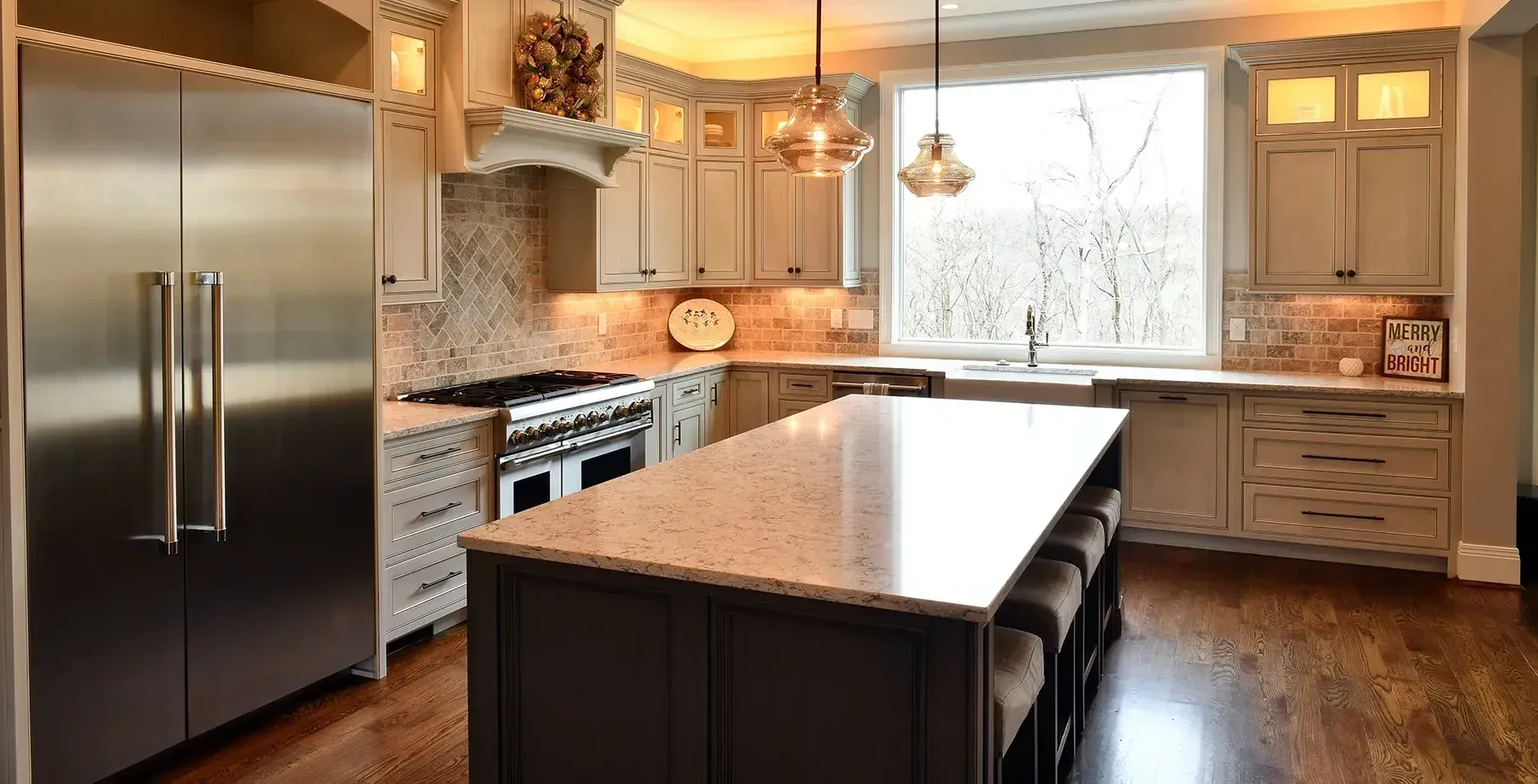 A kitchen with stainless steel appliances , granite counter tops , and a large island.