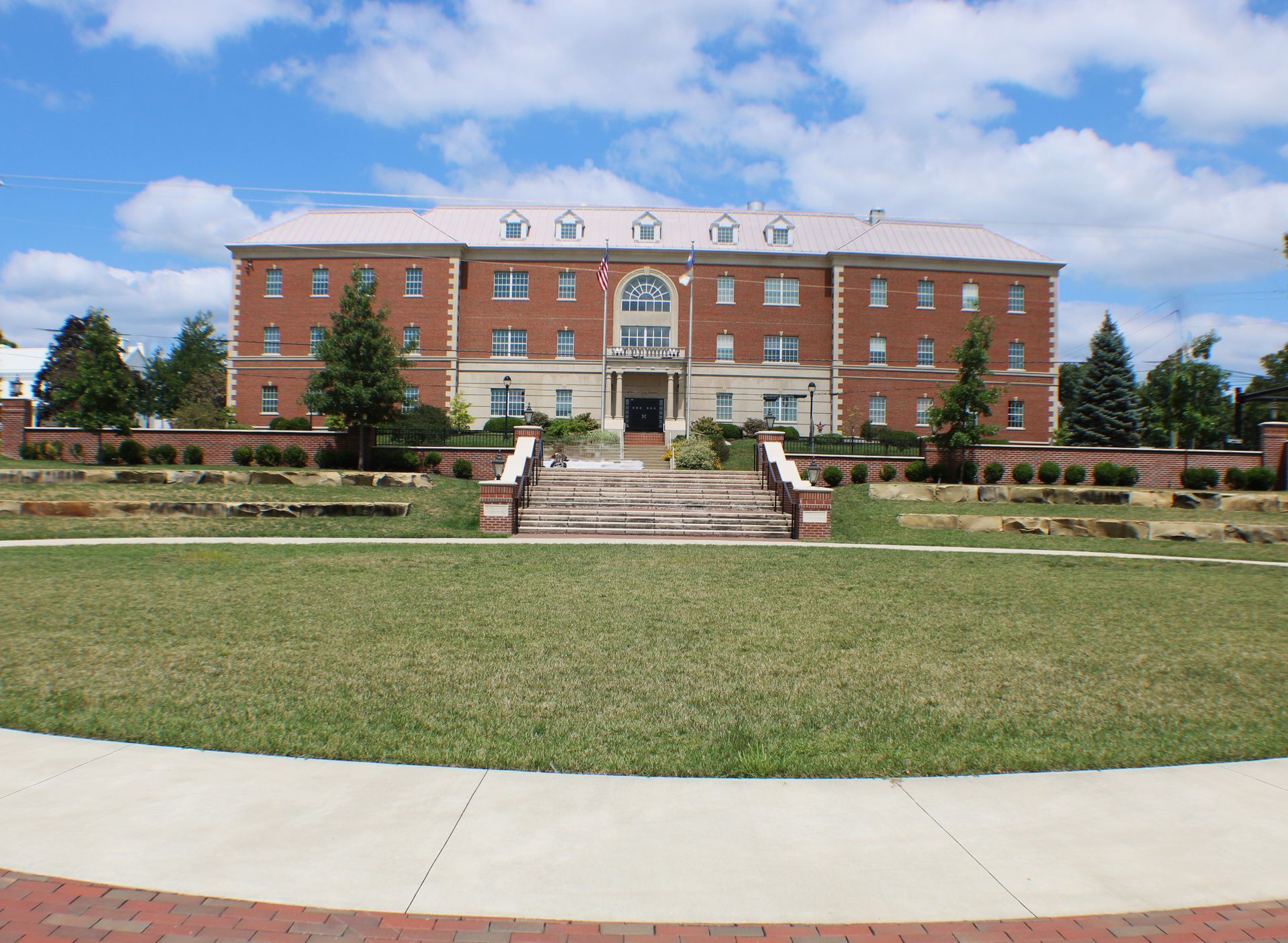 A large brick building with stairs leading up to it