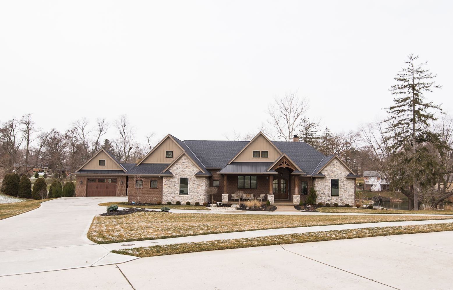 A large house with a concrete driveway in front of it.