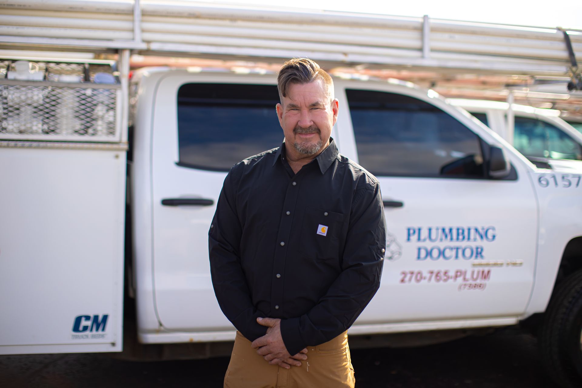 Man standing in front of a white truck that says