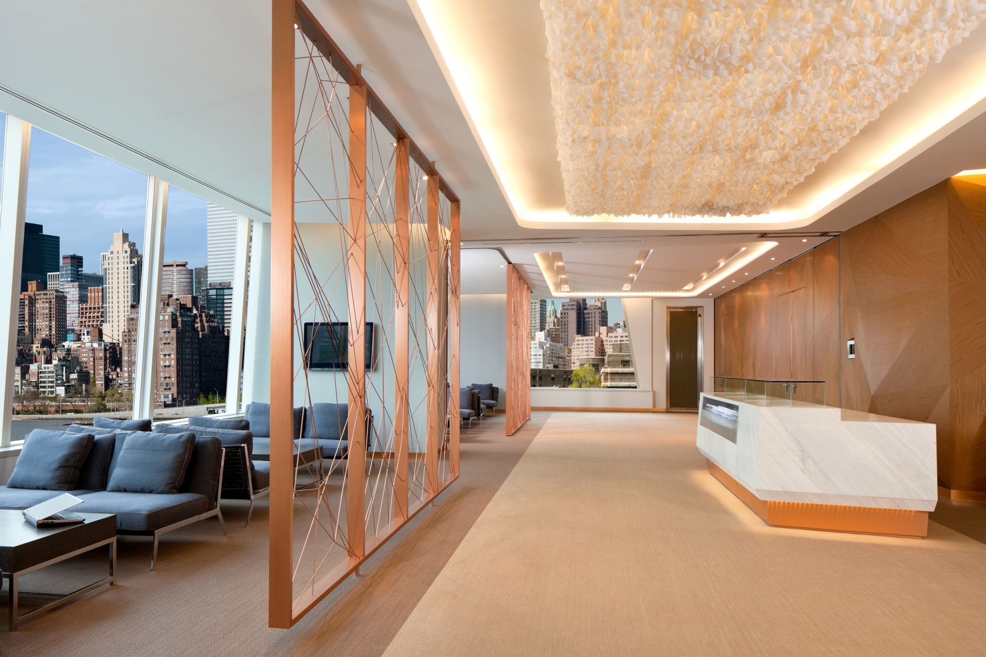 Modern office lobby with lounge seating and custom finishes by local commercial remodel contractors.