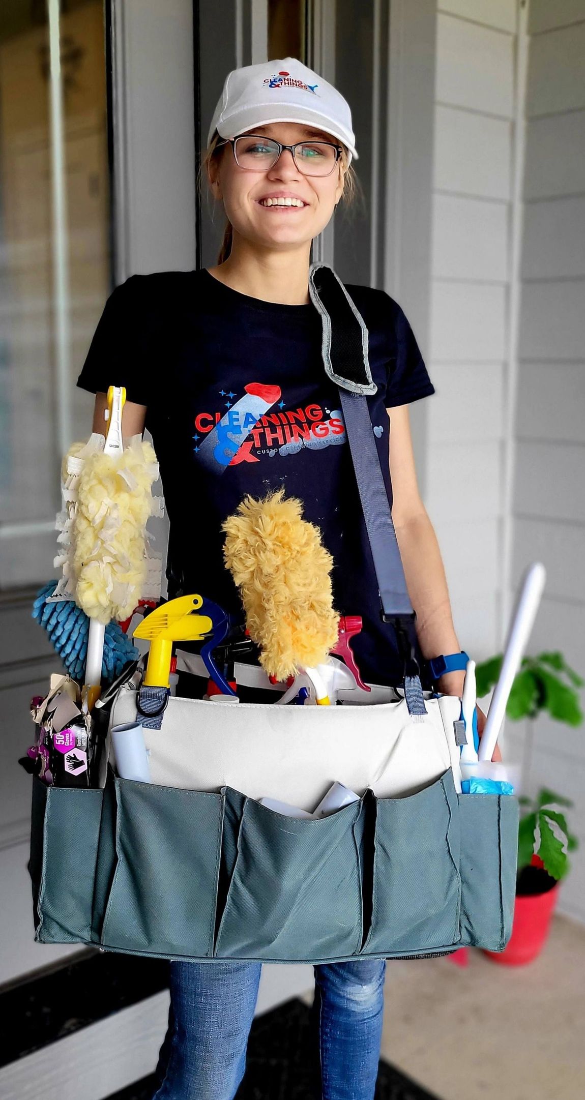 A woman is holding a bag full of cleaning supplies.