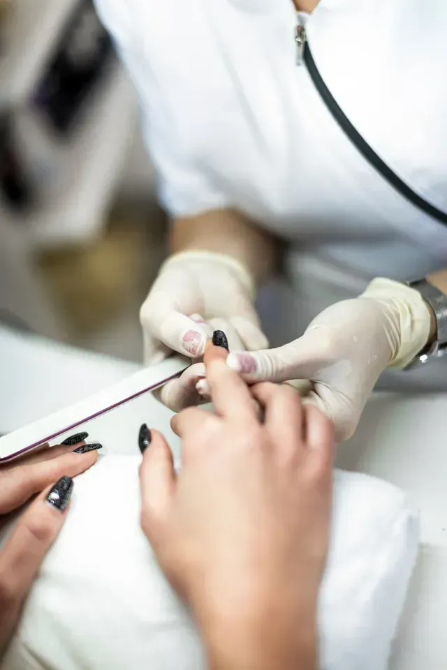 Beautician Removing Nailpolish of Client — Hagerstown, MD — Award Beauty School