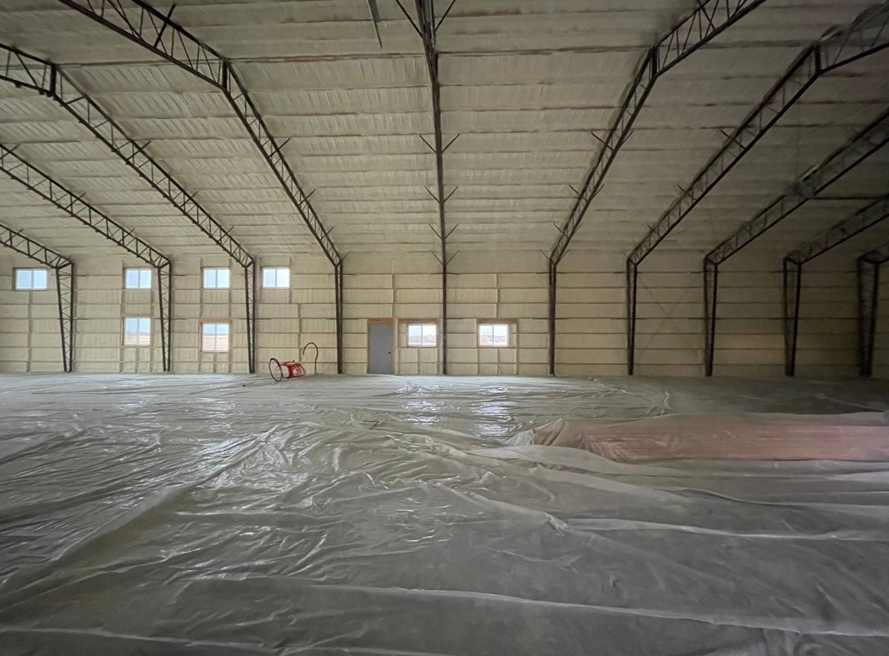 Person Is Spraying Insulation on A Wooden Wall — Nebraska City, NE — Midwest Custom Coatings