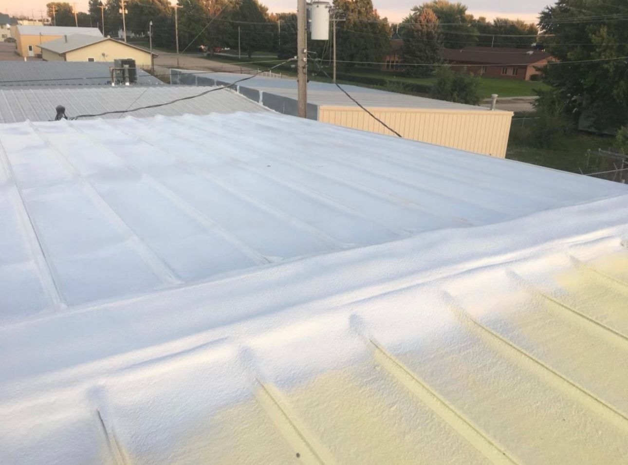 Two Workers Are Carrying Rolls of Insulation — Nebraska City, NE — Midwest Custom Coatings