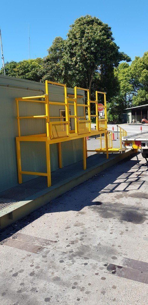 Yellow Stairs Are Set Up on the Side of a Building — AWE Engineering in South Lismore, NSW