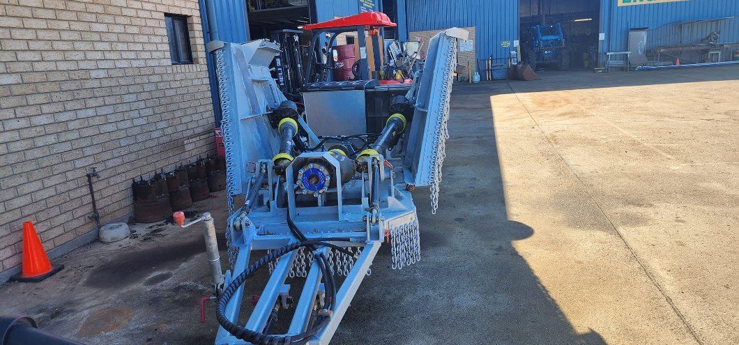 A Close Up of a Machine With a Large Wheel on a Dirt Field — AWE Engineering in South Lismore, NSW