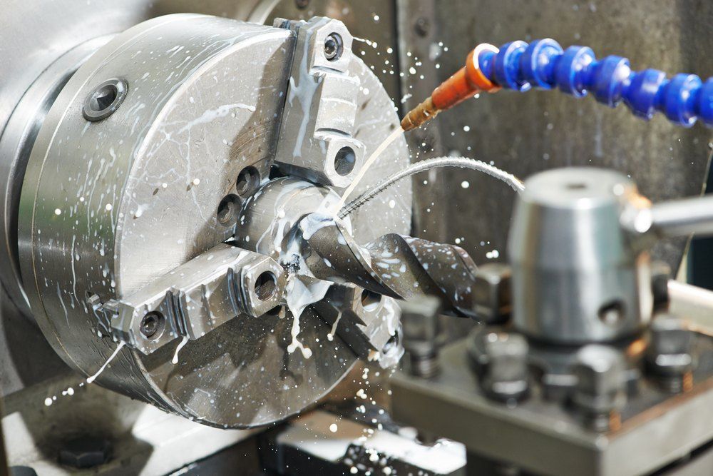 A Metal Workpiece is Being Machined on a Lathe, With Coolant Splashing — AWE Engineering in South Lismore, NSW