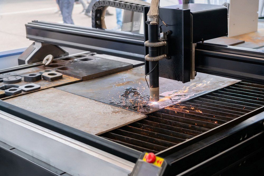 A Close Up of a Machine Cutting Metal With a Large Piece of Metal — AWE Engineering in South Lismore, NSW