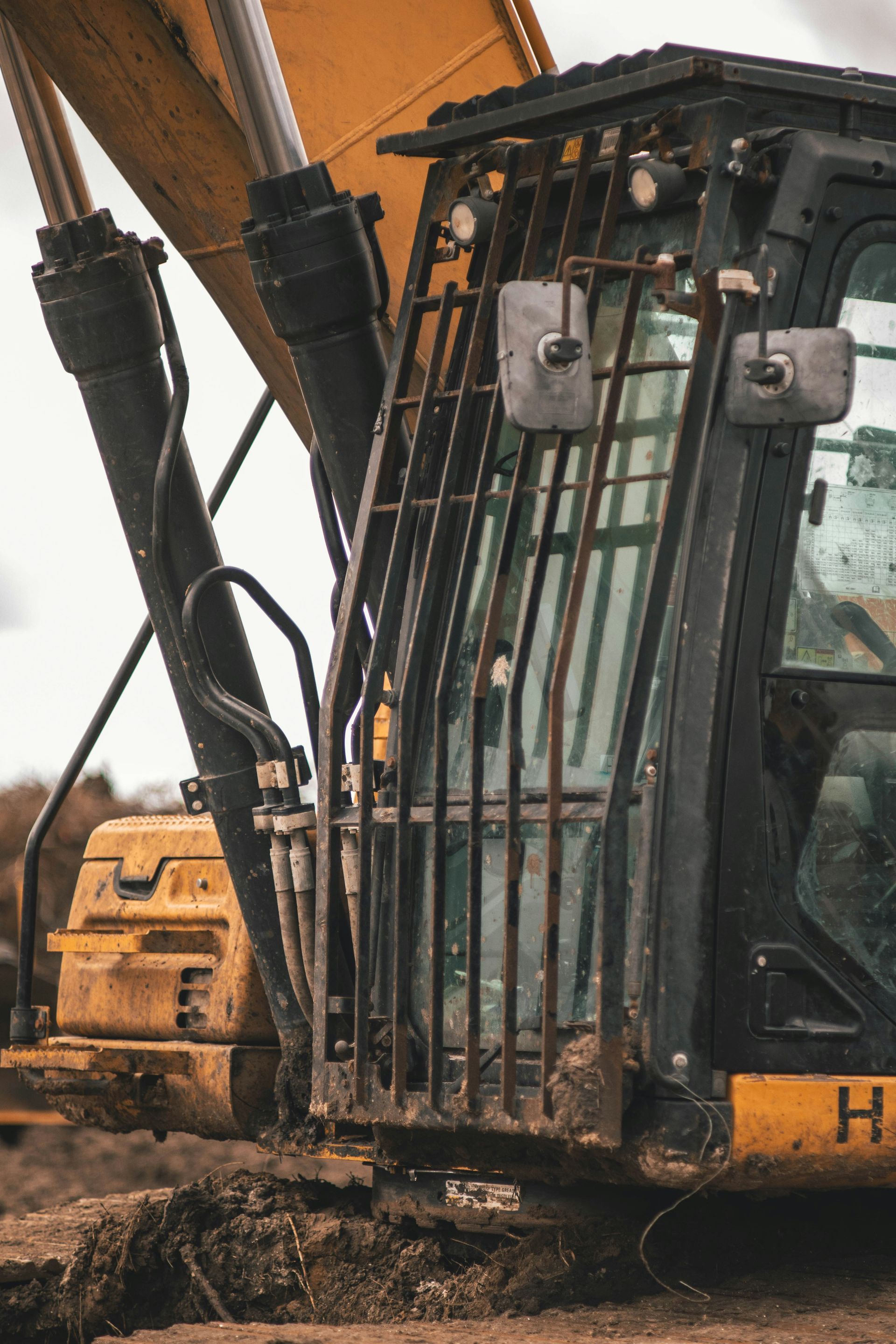 A Close up of a Black and Yellow Digger in Mud  — AWE Engineering in South Lismore, NSW