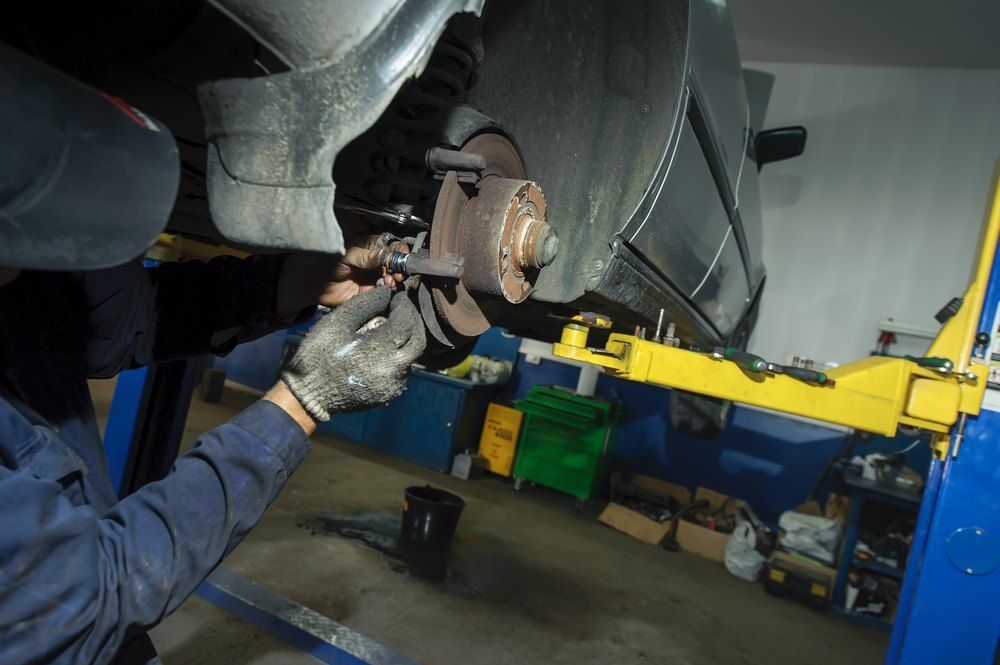 A Mechanic Works on a Car's Brake System — AWE Engineering in South Lismore, NSW