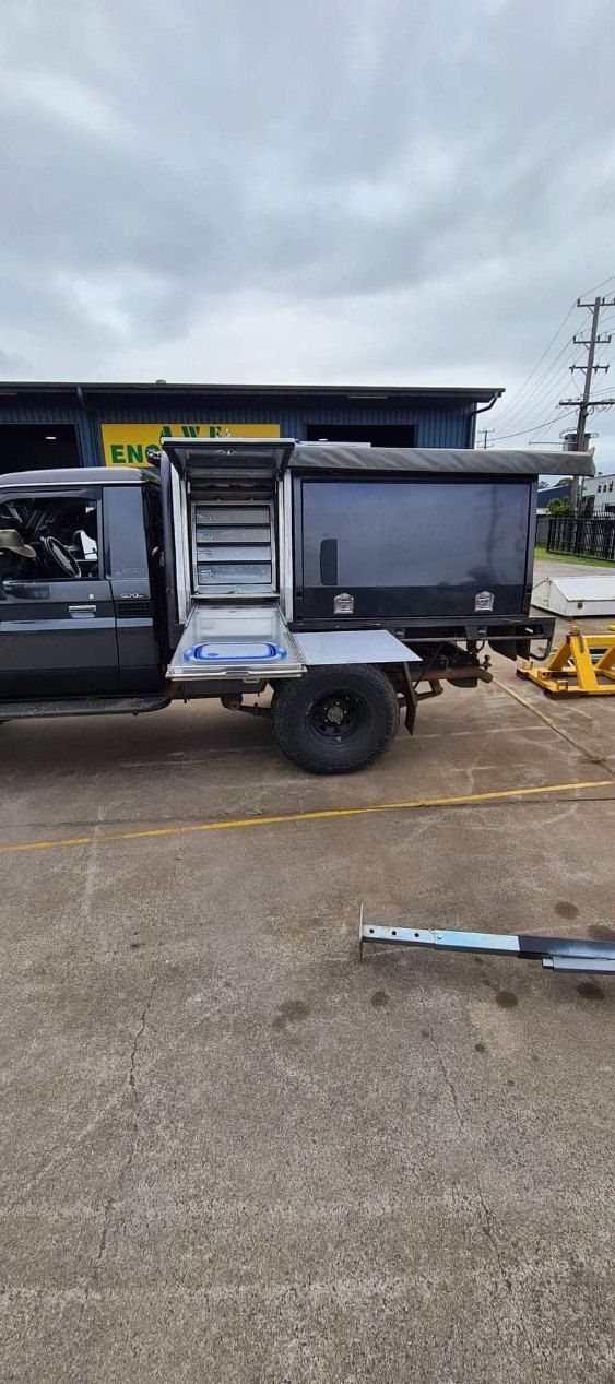 A Truck With a Trailer Attached to It is Parked in a Parking Lot — AWE Engineering in South Lismore, NSW