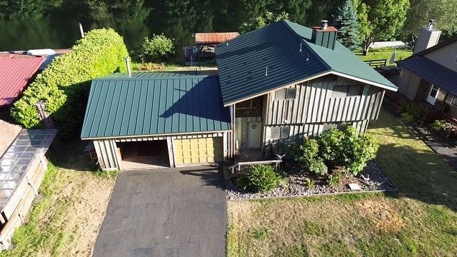 An aerial view of a house with a green roof