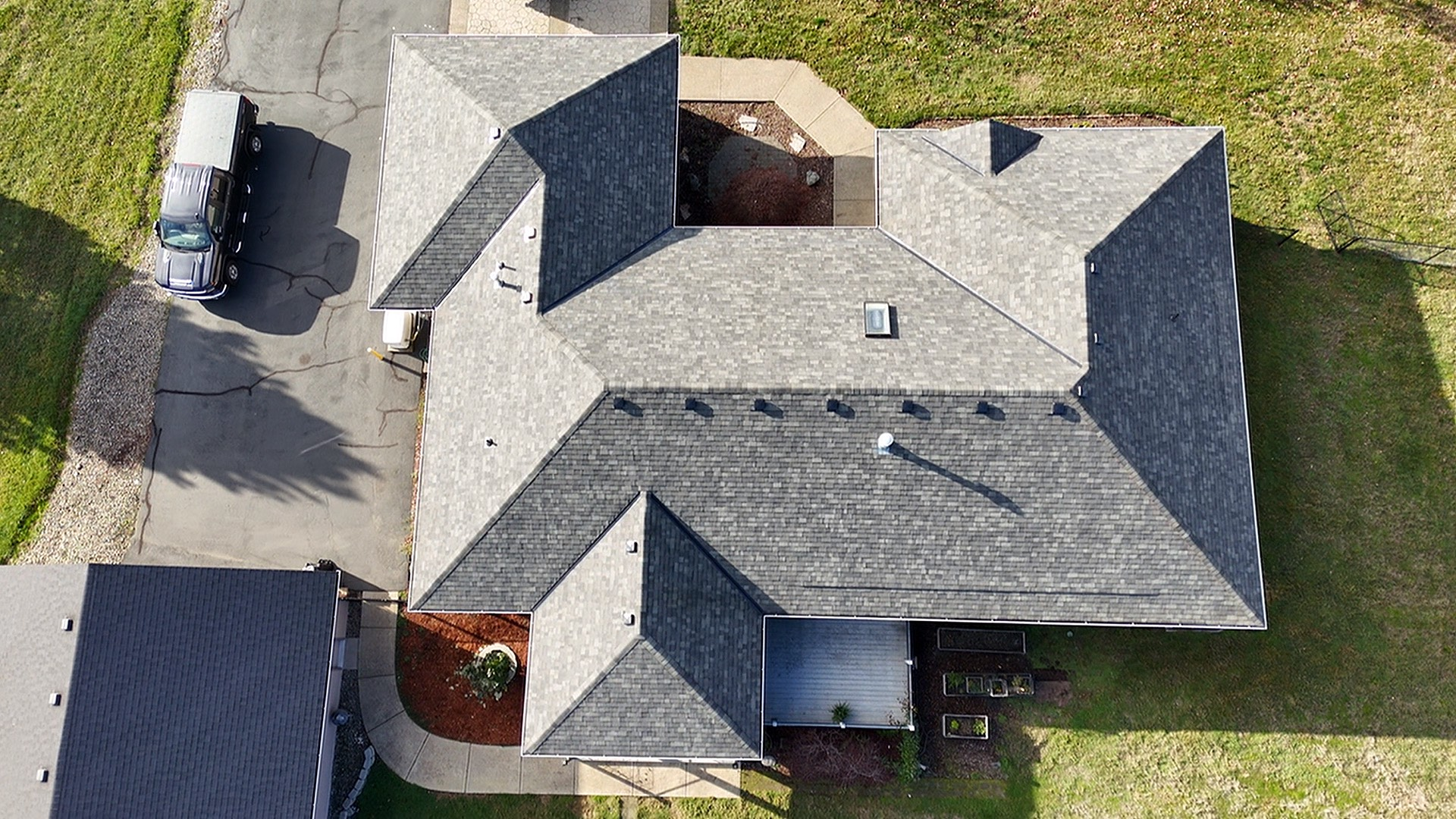 An aerial view of a house with a car parked in front of it.