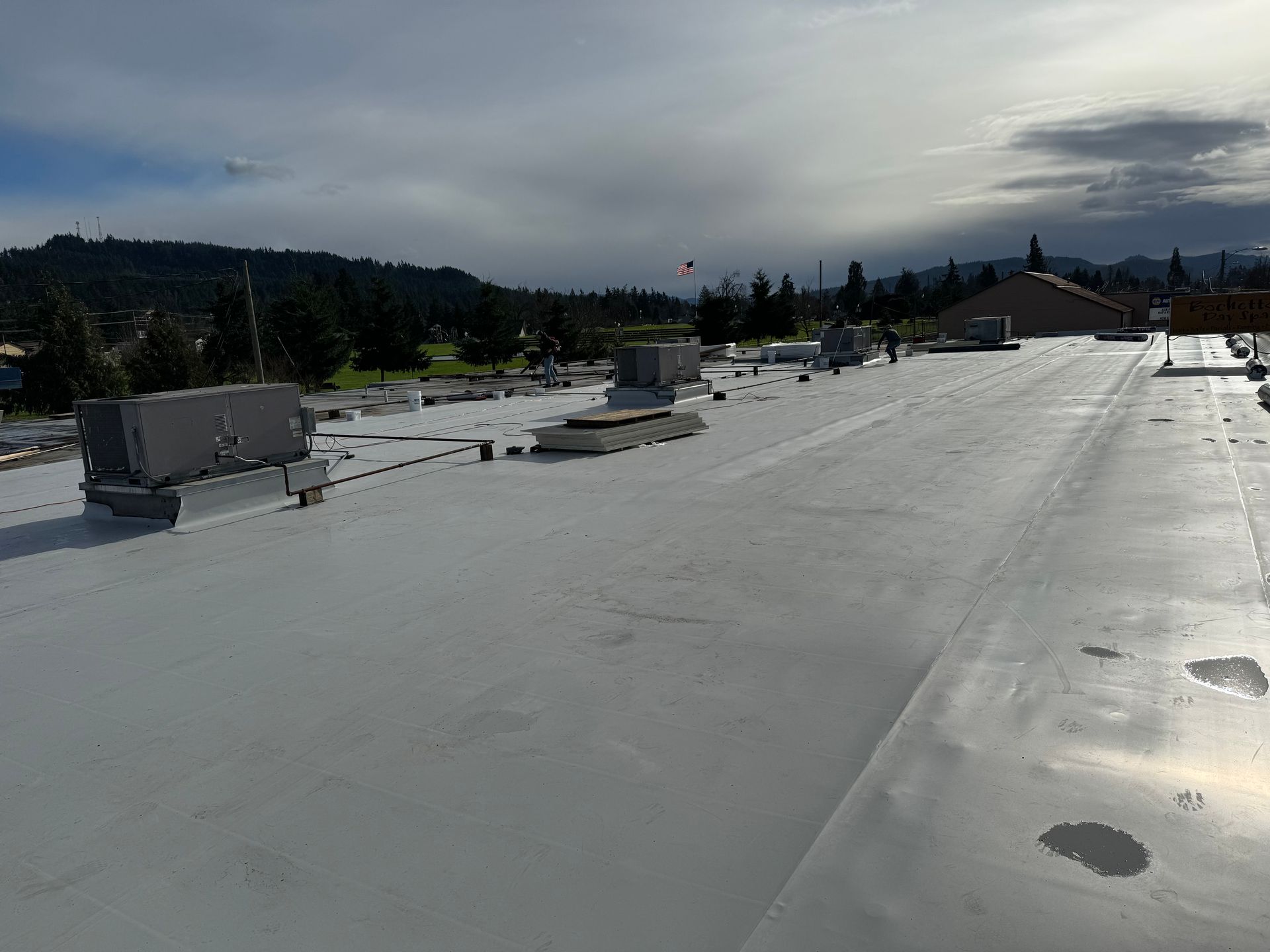 A large white roof with a mountain in the background