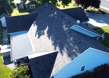 An aerial view of a house with a black roof