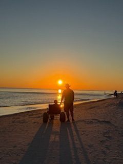 Wheelchair user enjoying sunset at Gulf Shores