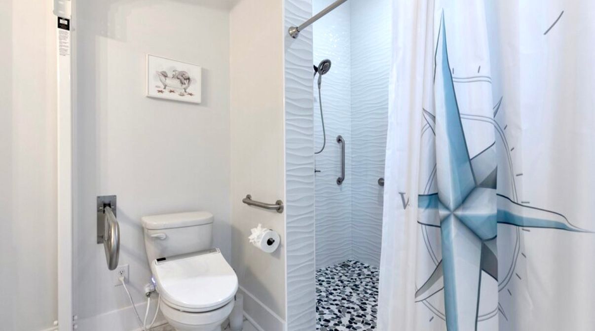 Handicap Accessible bathroom with built-in patient lift & roll in shower, grab bar, at Rest Ashore in Gulf Shores, Alabama