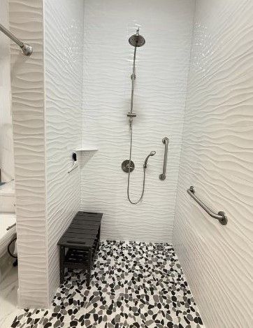 zero entry  oversized shower with grab bars and hand held shower wand & shower bench