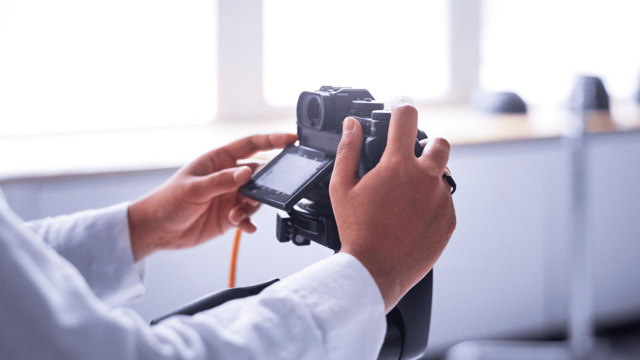 A person is holding a camera in their hands.