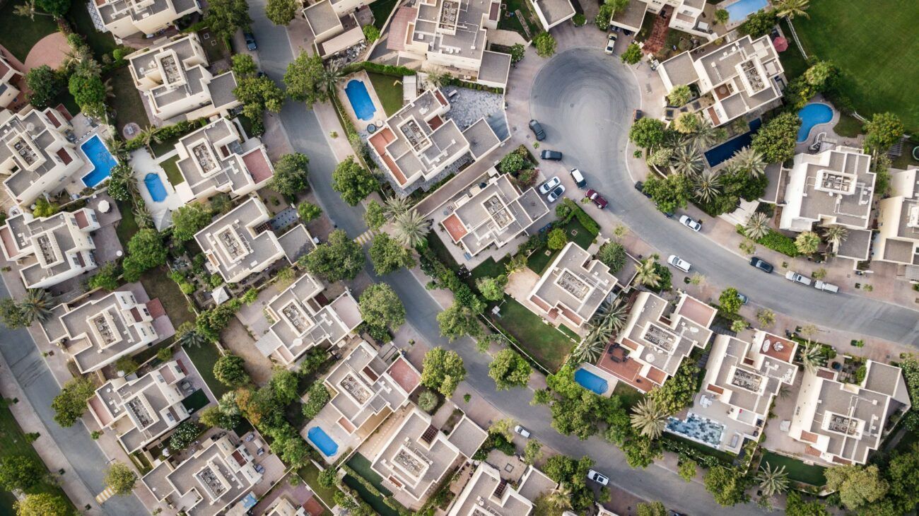 An aerial view of a residential area with lots of buildings and trees.