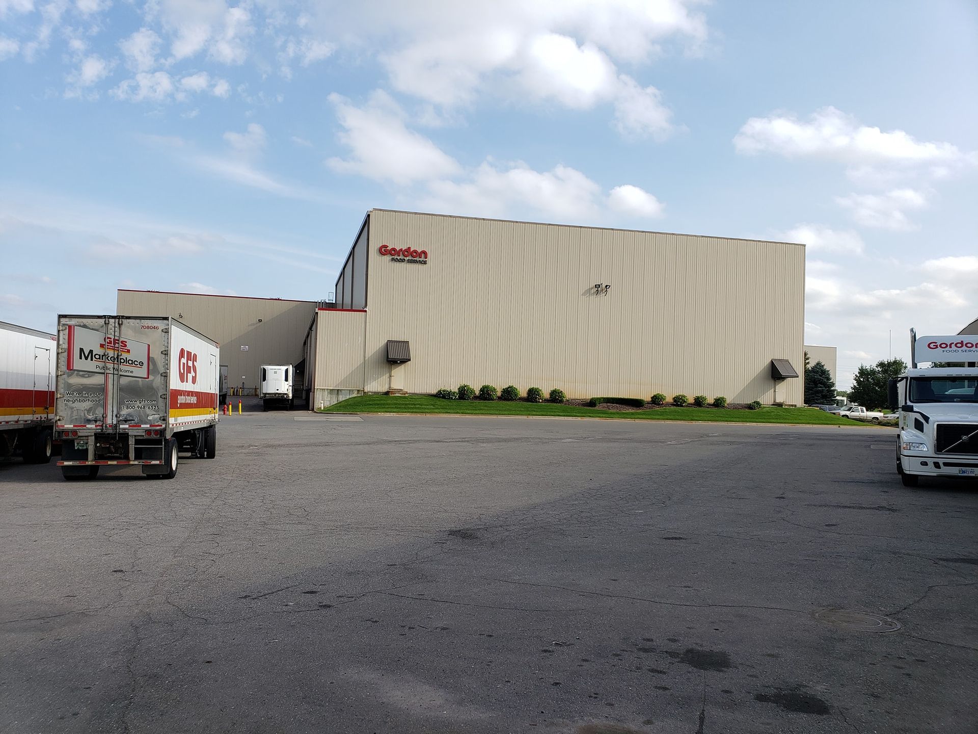 A large building with a lot of trucks parked in front of it