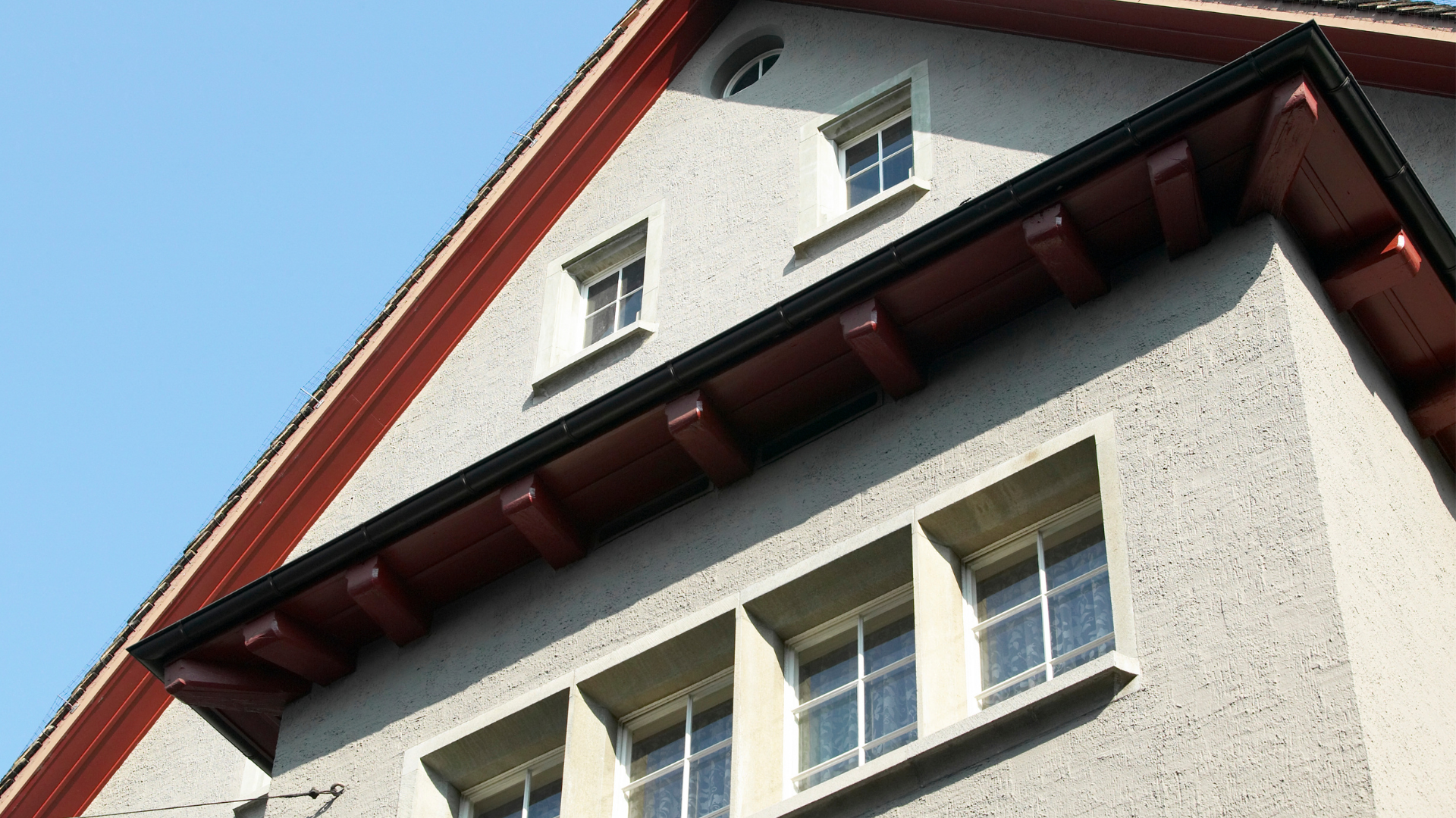 A building with a red roof and a lot of windows