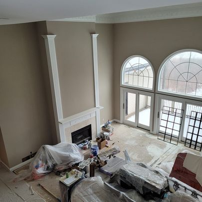 An aerial view of a living room with a fireplace and lots of windows.