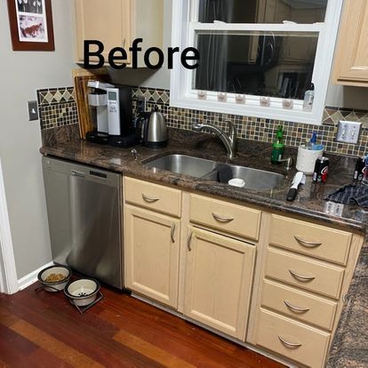 A kitchen with stainless steel appliances and wooden cabinets before being remodeled.