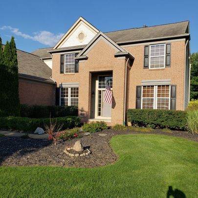 A large brick house with a flag on the front door