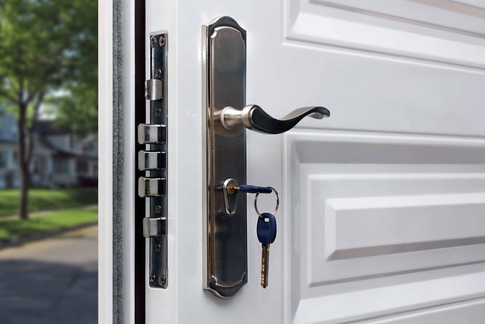 A close up of a door with a key in the lock.