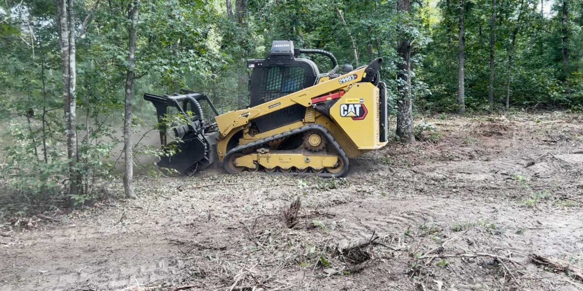 Excavator mixing organic materials for industrial composting through land mulching process