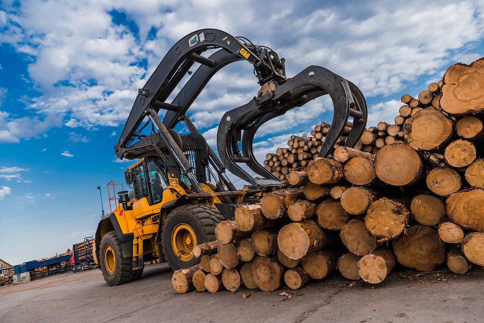 Excavator mixing organic materials for industrial composting through land mulching process