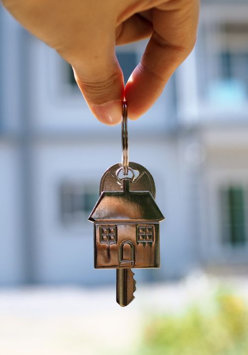 A finance broker holding a set of keys