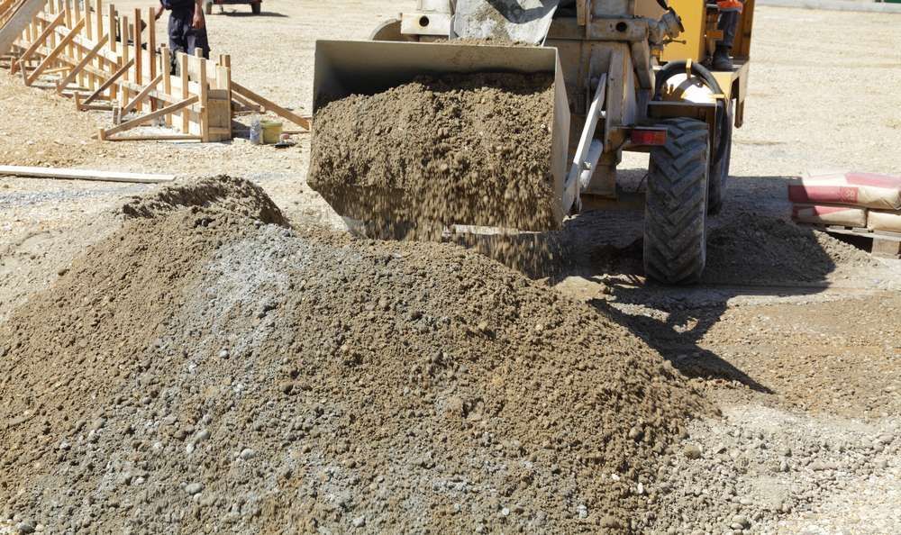 A Bulldozer Is Loading Dirt Into A Pile On A Construction Site — HKL Landscape Supplies in Gloucester, NSW 