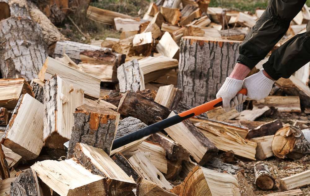 Hands In White Gloves With A Cleaver, Firewood Is Stuck — HKL Landscape Supplies in Coolongoolook, NSW