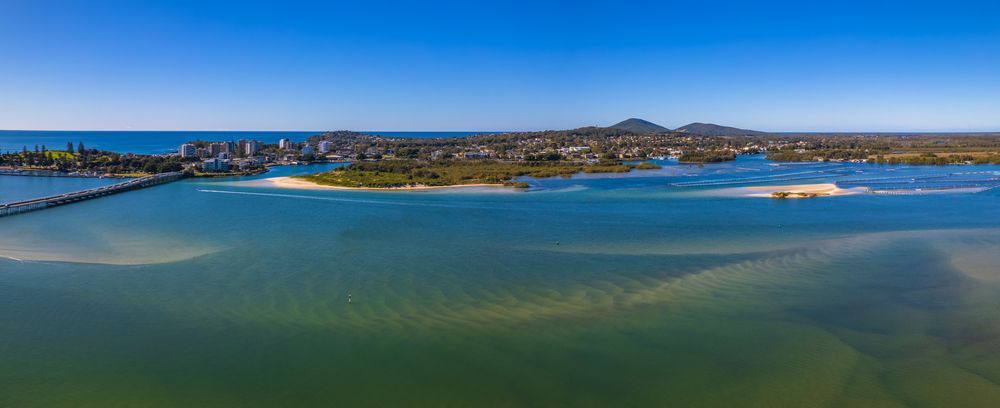 An Aerial View of a Body of Water With a City in the Background — HKL Landscape Supplies in Forster, NSW
