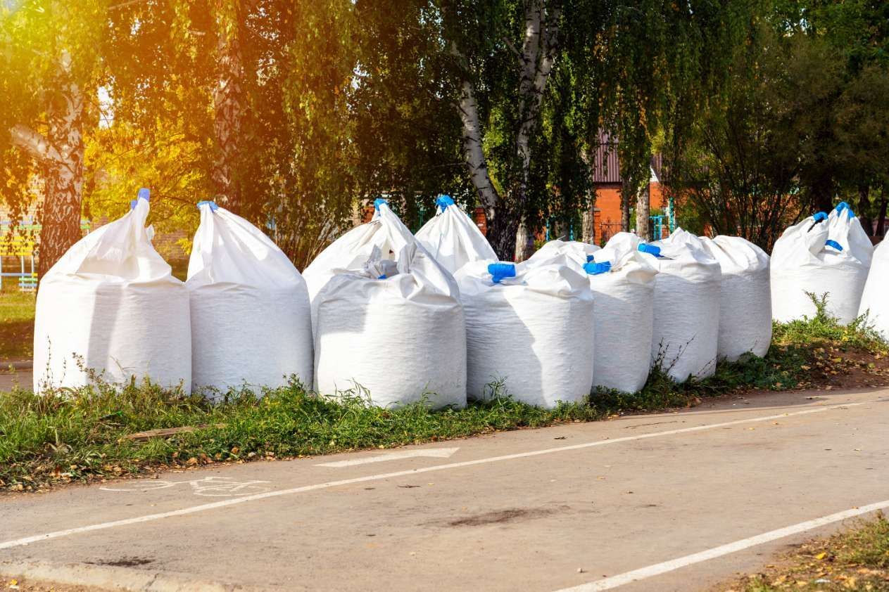 A Row Of White Bags Sitting On The Side Of A Road — HKL Landscape Supplies in Bulahdelah, NSW