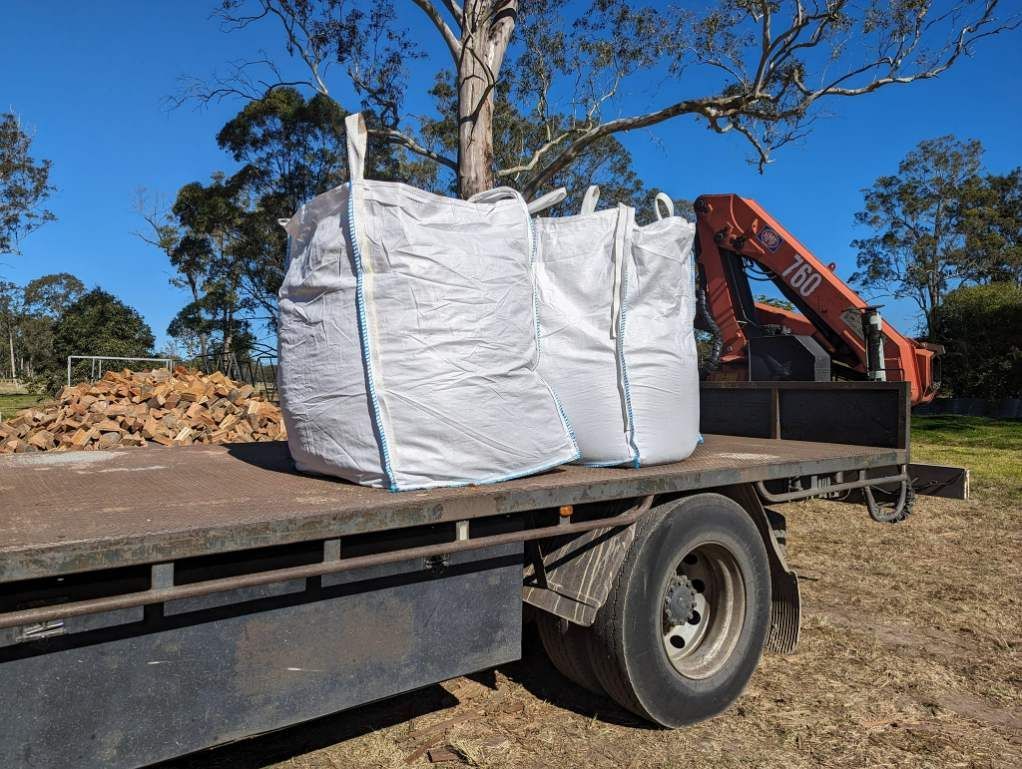 A Truck With Two Bags On The Back Of It — HKL Landscape Supplies in Taree South, NSW